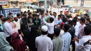 Flag hoisting ceremony at Gyanam Junior College on Independence Day with students performing cultural programs in the background.