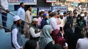 Flag hoisting ceremony at Gyanam Junior College on Independence Day with students performing cultural programs in the background.