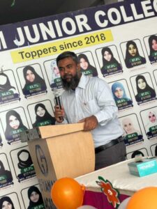 Flag hoisting ceremony at Gyanam Junior College on Independence Day with students performing cultural programs in the background.