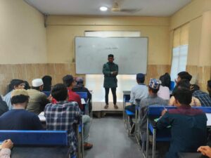 Flag hoisting ceremony at Gyanam Junior College on Independence Day with students performing cultural programs in the background.