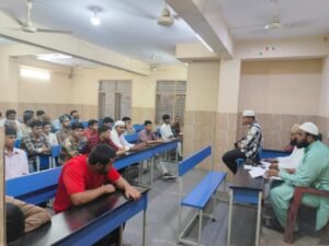 Flag hoisting ceremony at Gyanam Junior College on Independence Day with students performing cultural programs in the background.
