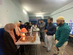 Flag hoisting ceremony at Gyanam Junior College on Independence Day with students performing cultural programs in the background