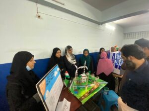 Flag hoisting ceremony at Gyanam Junior College on Independence Day with students performing cultural programs in the background.
