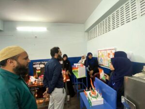 Flag hoisting ceremony at Gyanam Junior College on Independence Day with students performing cultural programs in the background.